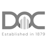 DOC Construction grayscale logo - a client of HammerTech and a user of HammerTech's construction intelligence safety software for better site safety.